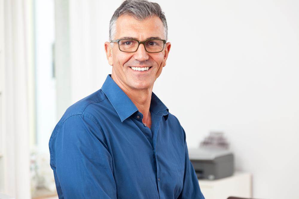 a smiling man who is eager to learn about the signs of low testosterone