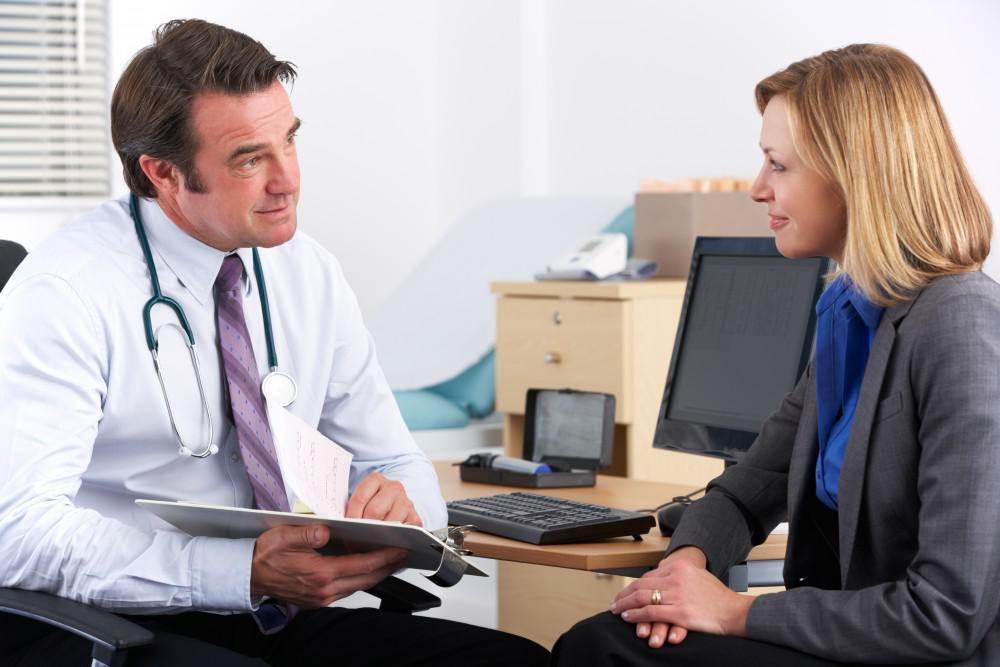 Doctor and patient happily discuss therapy for chronic pain.